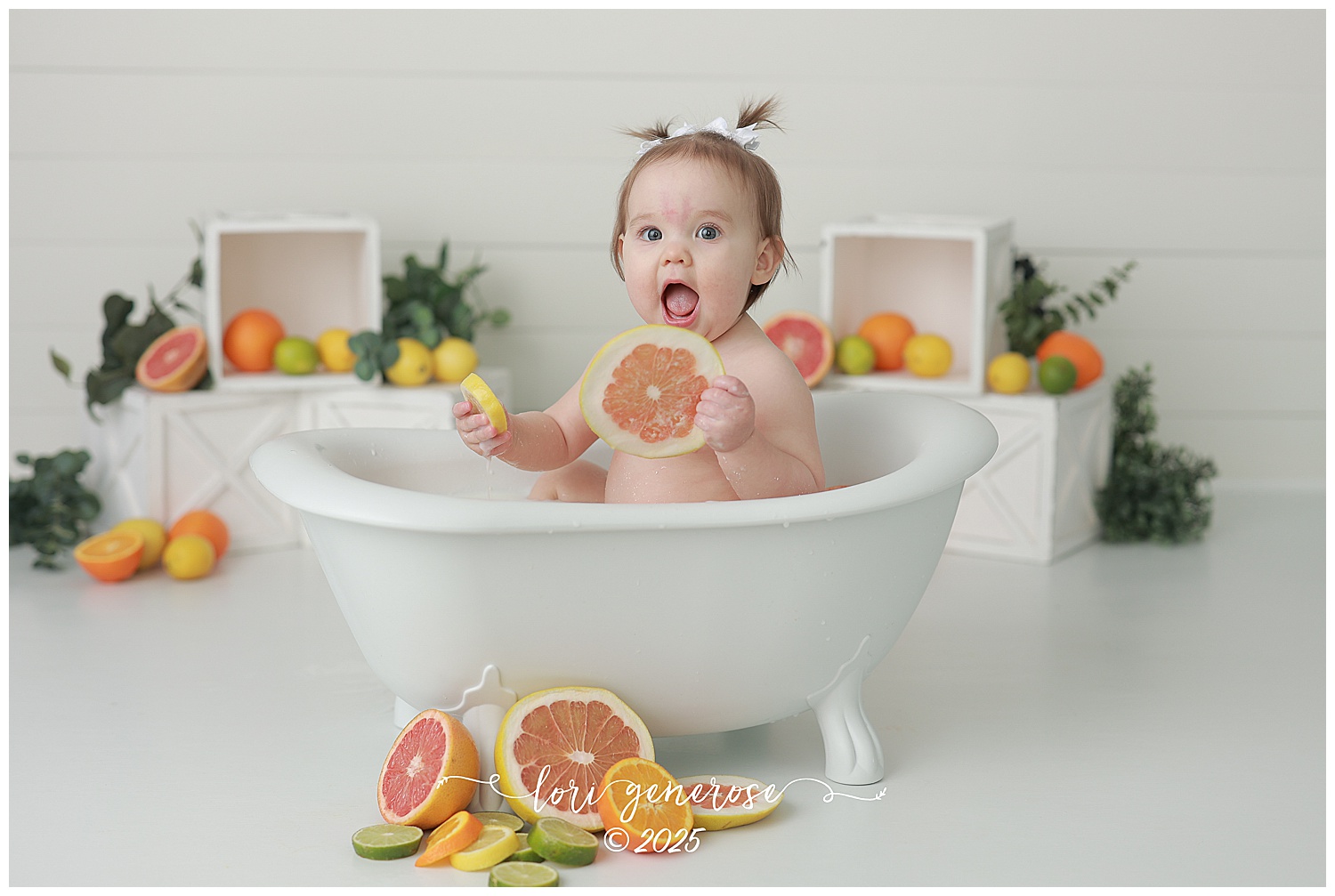 One year old girl sitting in bathtub for citrus fruit milk bath first birthday photos