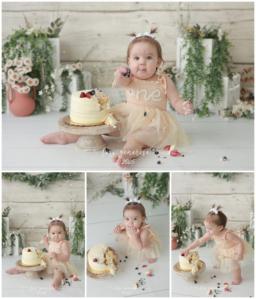 One year old girl first birthday girl cake smash with a cream colored cake with strawberries and blueberries, a Berry Chantilly cake from Whole Foods she is sitting by her cake and eating it