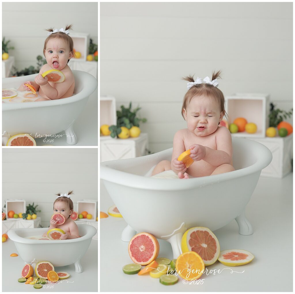 One year old girl sitting in bathtub for citrus fruit milk bath first birthday photos, making sour faces because she is eating the fruit