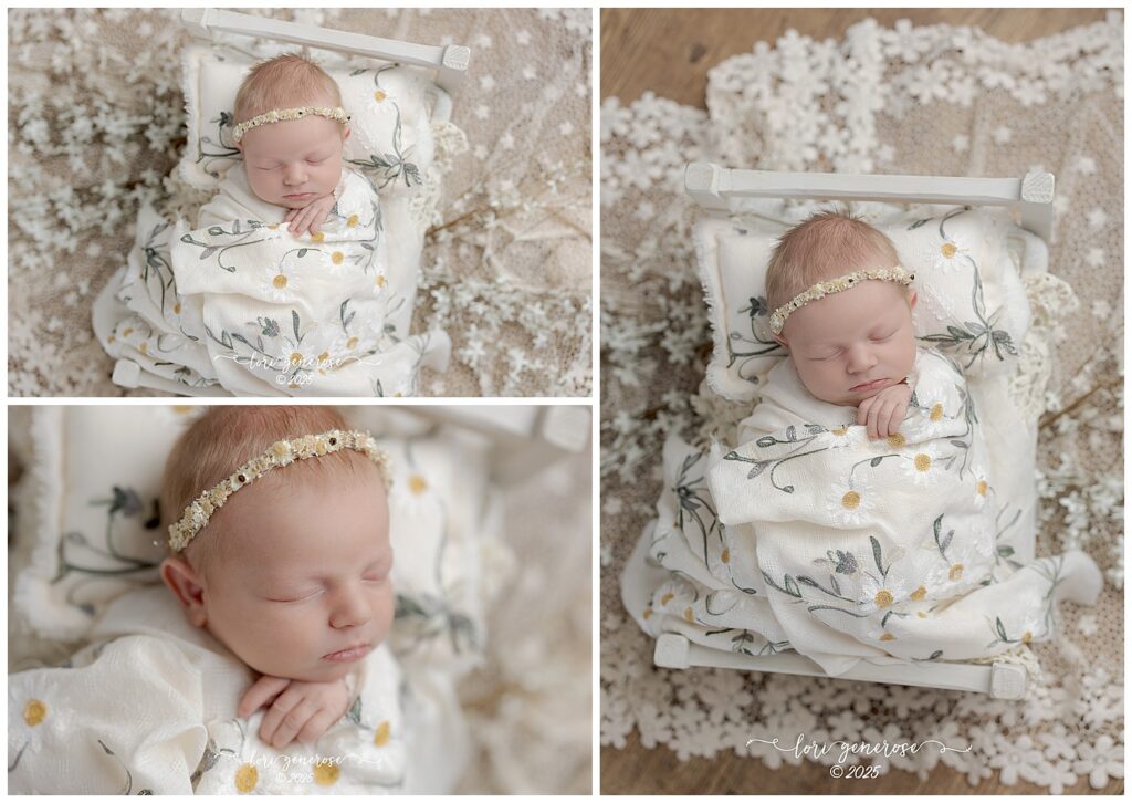 Beautiful newborn baby girl photographed by Lehigh Valley newborn photographer Lori Generose in Lehigh Valley, PA – posed in a cozy wooden newborn bed with lace blanket underneath and a boho daisy wrap and pillow during a professional studio newborn session.