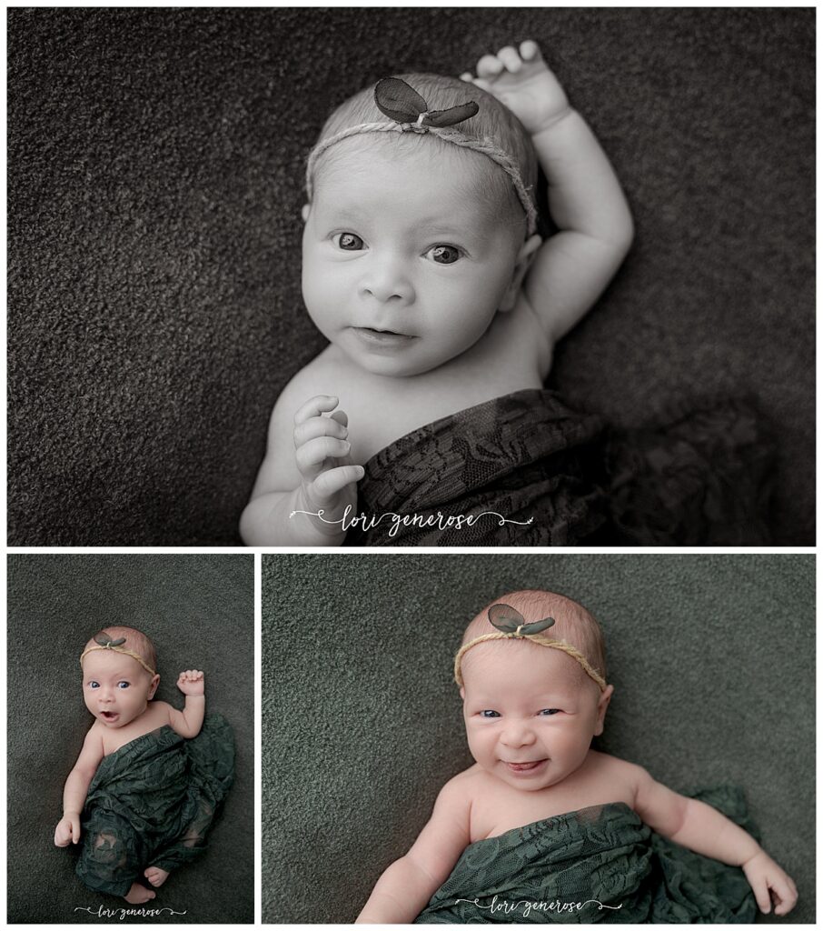 Newborn baby girl wide awake with a cream lace wrap across her while laying on a dark green blanket with a twine and green leaves headband by Lehigh Valley newborn photographer Lori Generose of LG Photography