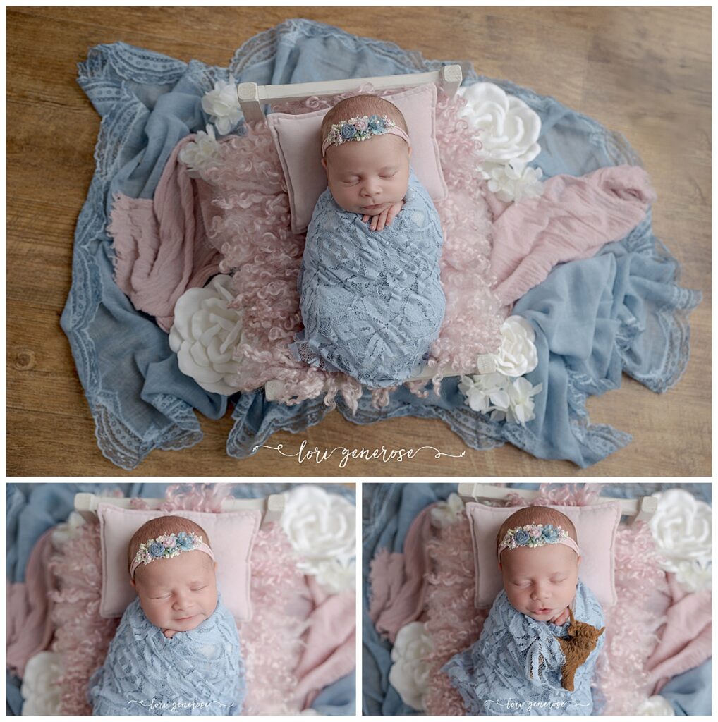 newborn baby girl in a lace dusty blue wrap on a newborn bed prop with pink fur, a pink pillow and accents of white florals and pink and blue wraps on a wood floor, one photo shows her holding a Highland cow prop by Lehigh Valley newborn photographer Lori Generose of LG Photography