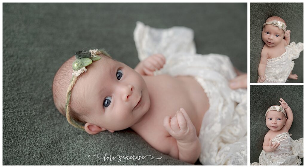 Newborn baby girl wide awake with a cream lace wrap across her while laying on a dark green blanket with a twine and green leaves headband by Lehigh Valley newborn photographer Lori Generose of LG Photography