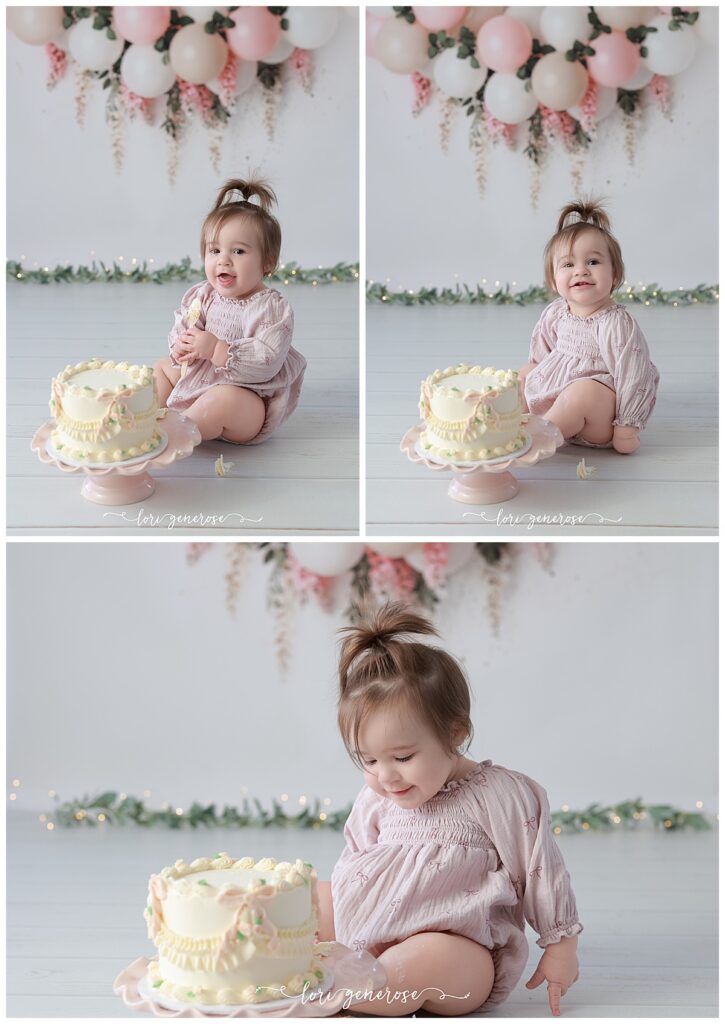 One year old girl cake smash portraits with pink and cream balloon garland with pink hanging wisteria flowers. Baby has a cream cake with vintage and pink bows from LG Photography, Lori Generose who is a Lehigh Valley cake smash photographer