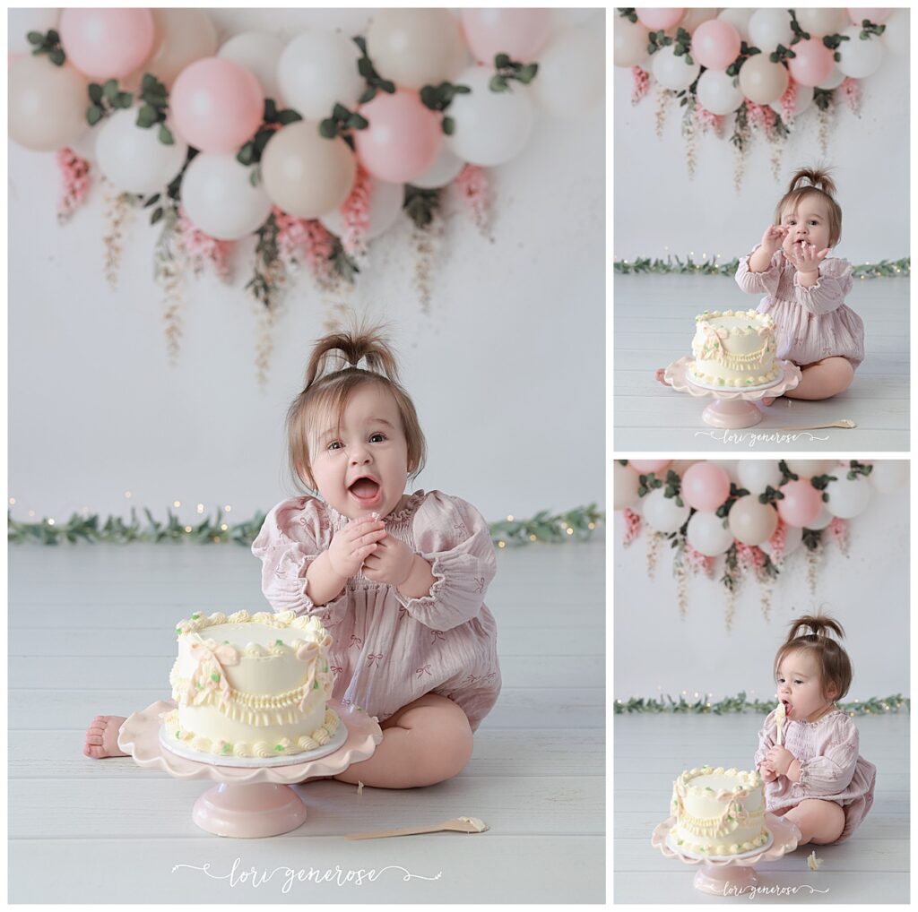 One year old girl cake smash portraits with pink and cream balloon garland with pink hanging wisteria flowers. Baby has a cream cake with vintage and pink bows from LG Photography, Lori Generose who is a Lehigh Valley cake smash photographer