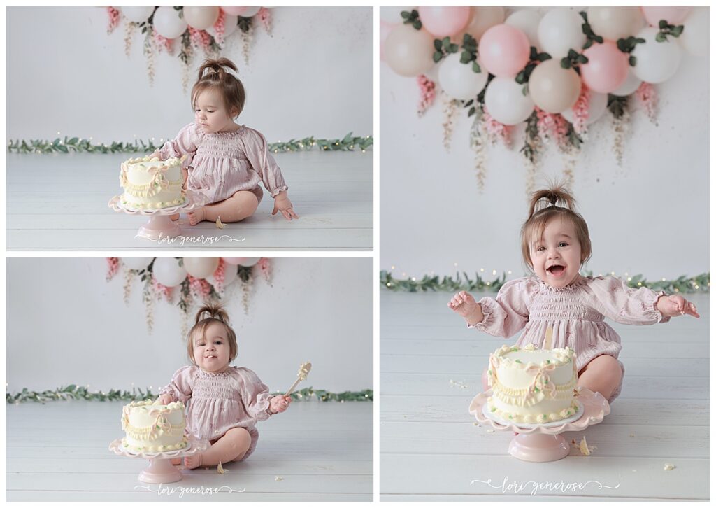 One year old girl cake smash portraits with pink and cream balloon garland with pink hanging wisteria flowers. Baby has a cream cake with vintage and pink bows from LG Photography, Lori Generose who is a Lehigh Valley cake smash photographer