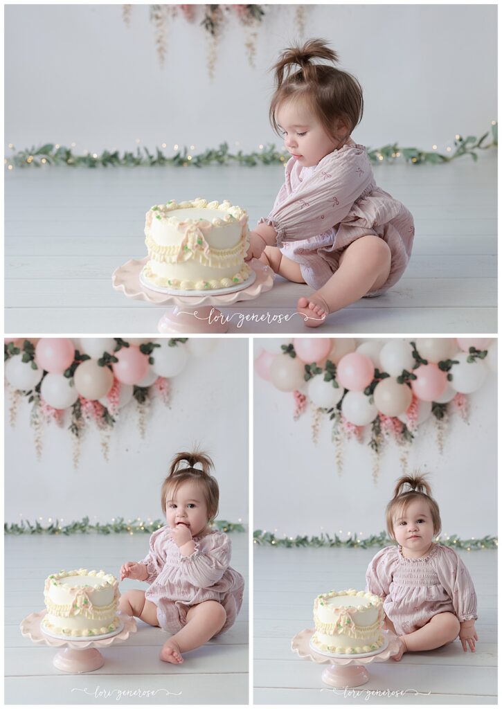 One year old girl cake smash portraits with pink and cream balloon garland with pink hanging wisteria flowers. Baby has a cream cake with vintage and pink bows from LG Photography, Lori Generose who is a Lehigh Valley cake smash photographer