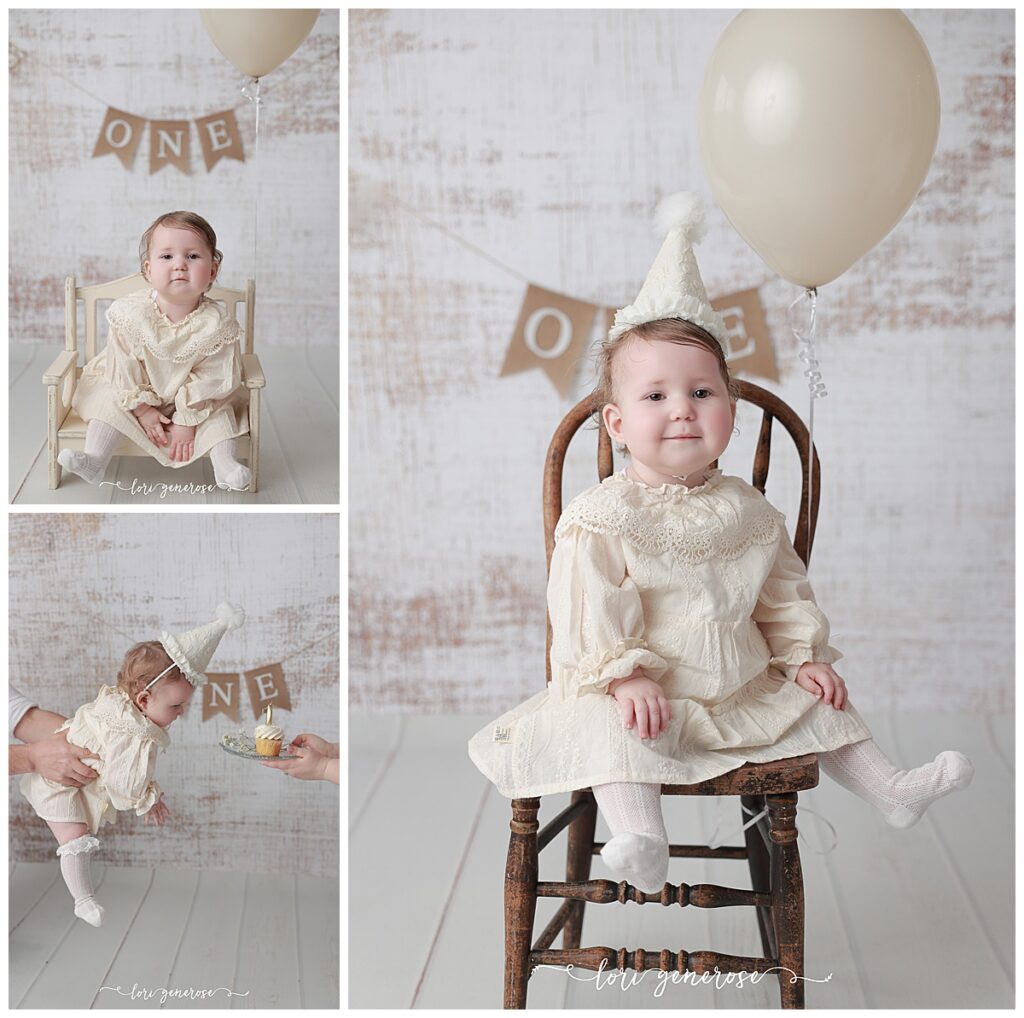 First birthday girl in a cream classic dress with a cream cone party hat for her cake smash session with Lori Generose of LG Photography, a Lehigh Valley Photographer