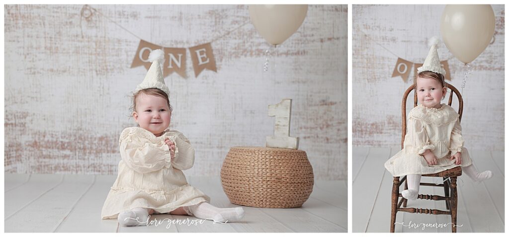 First birthday girl in a cream classic dress with a cream cone party hat for her cake smash session with Lori Generose of LG Photography, a Lehigh Valley Photographer