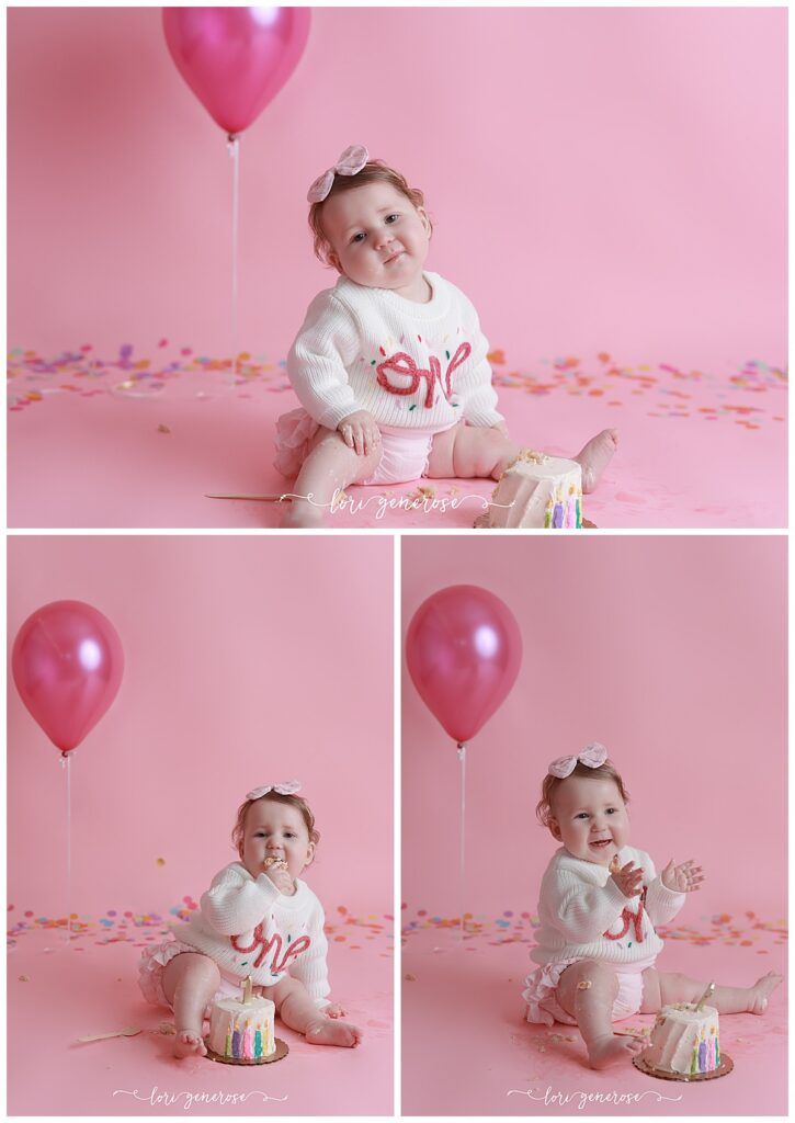 First birthday girl in a ONE with confetti sweater on a pink seamless paper backdrop with one single pink balloon and paper confetti for her cake smash session with Lori Generose of LG Photography, a Lehigh Valley Photographer
