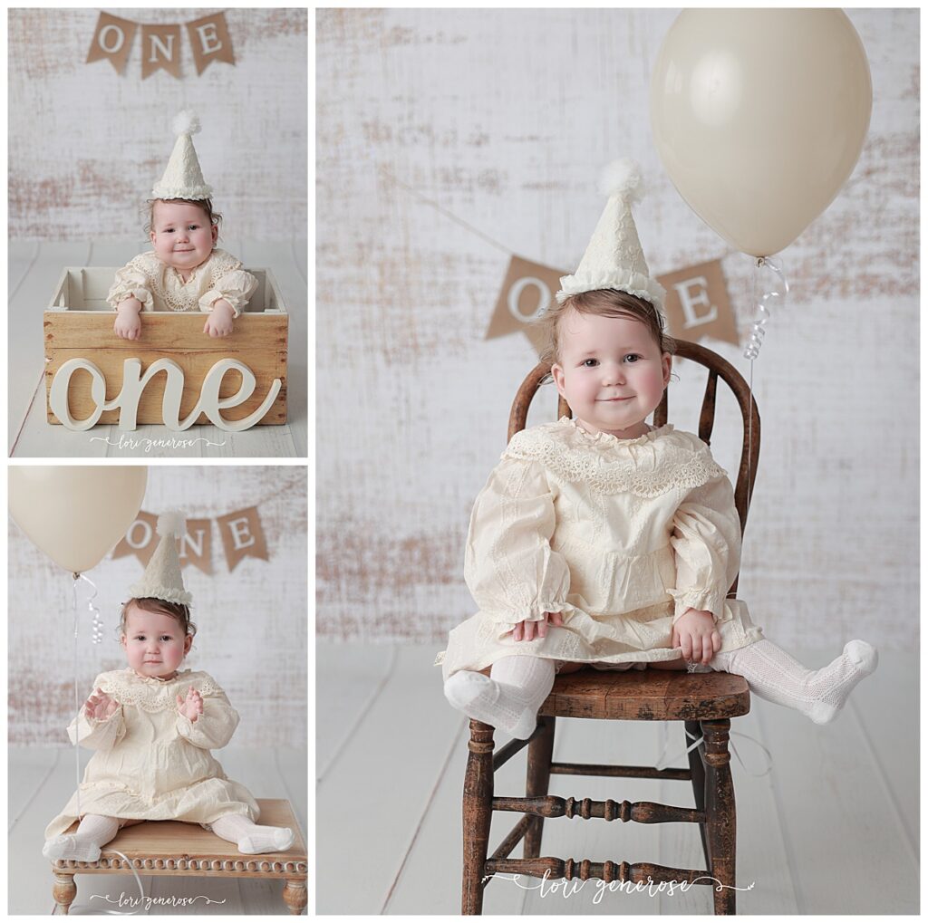 First birthday girl in a cream classic dress with a cream cone party hat for her cake smash session with Lori Generose of LG Photography, a Lehigh Valley Photographer